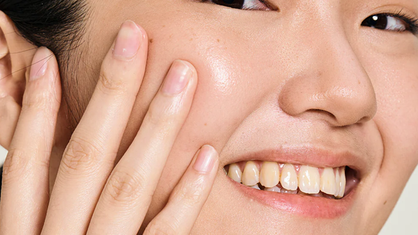 A Woman Happily Applying Aquafix Hydrating Water Gel On Her Face