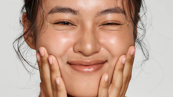 A Woman Smiling After Using Double Play Retinol