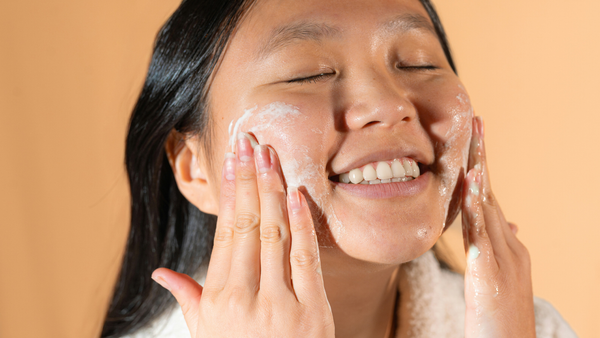 A Woman Using Circular Motions To Apply Facial Cleanser