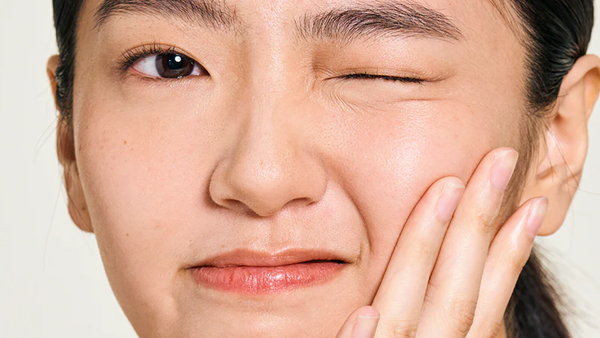 A Woman With A Fresh Face After Exfoliating With Gold Standard