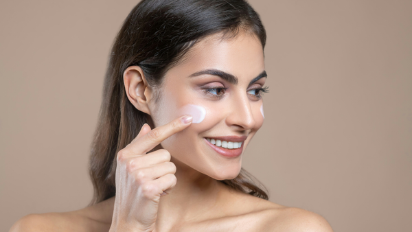 Woman Applying A Moisturizer With Ceramides
