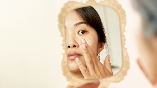 Woman Applying A Moisturizer With Ceramides